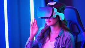 Portrait of young beautiful asian woman wearing virtual reality glasses vr headset for play video game feeling excited 4K resolution