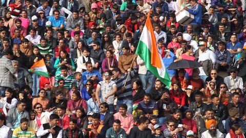 WAGAH, INDIA - JANUARY 26, 2017: Crowd of Indian spectators watch the military ceremony at India-Pakistan border in Wagah in Punjab, India.