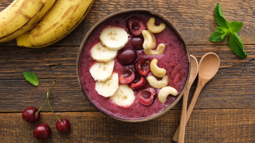 Stop Motion Animation Preparing Healthy Vegan Acai Berry Smoothie Bowl. Superfood Purple Smoothie With Fruit And Nut Toppings | Shutterstock HD Video #1054689536