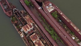 Rusted shipwrecks are in a bay near by Pilismarot. This bay is in the amazing Danube bend. Abandoned industrial ships what pollute the environment.