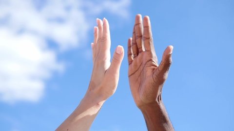 Friendship, anti-racism, fraternity-white hand and black hand are given the five. Stop racism, all people are equal. White and black hand connect. Friendship of Peoples.