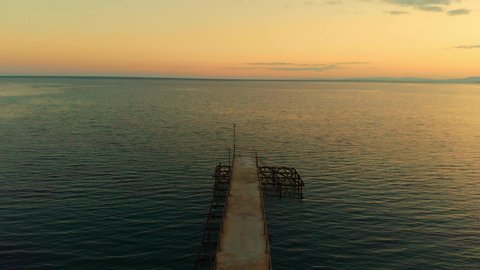Scenic Sunset View Of Jetty Over The Calm Sea Near The Shore In Nessebar, Bulgaria - high angle wide shot