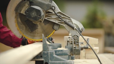 Slow Motion Close Up of Table Saw Cutting Wood on Construction Site