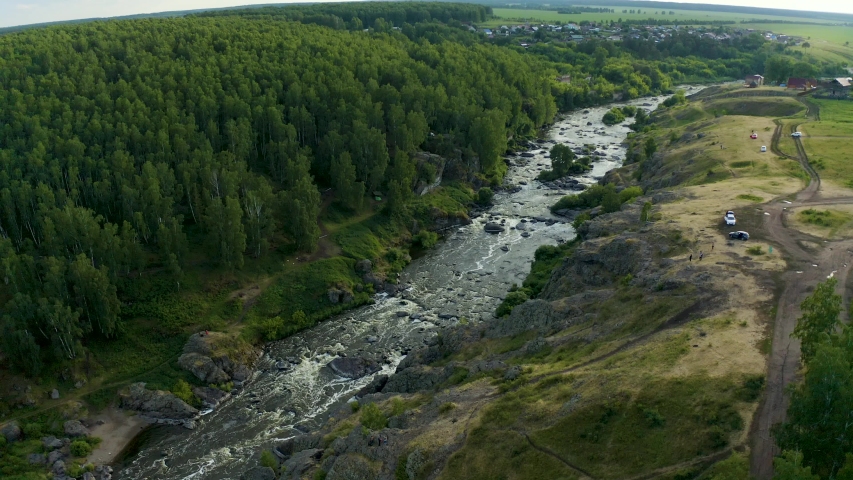 Ural Mountains. Rocks and rocky rifts on a mountain river in summer. View from drone on the valley and the river Iset with rocky banks. Royalty-Free Stock Footage #1054701596