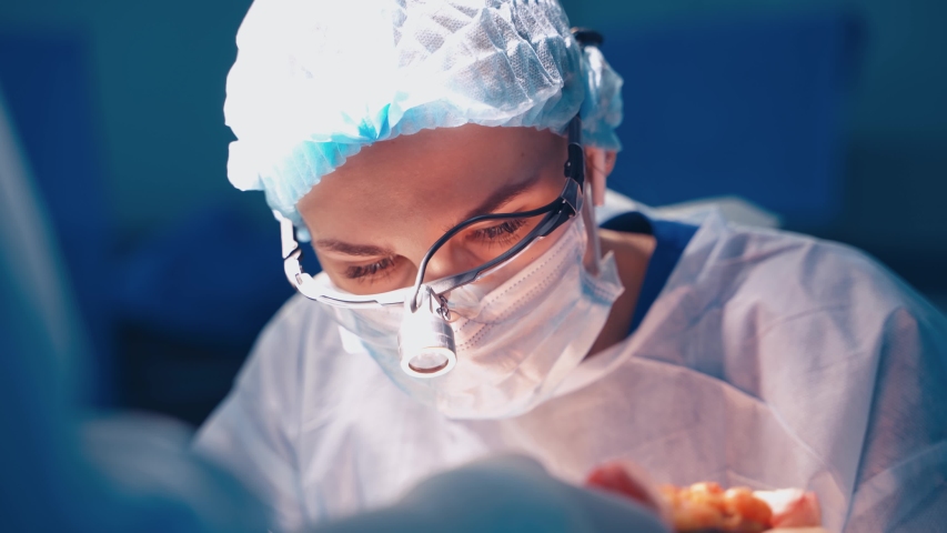 Portrait of doctor during surgery. Doctor concentrating on patient during surgery