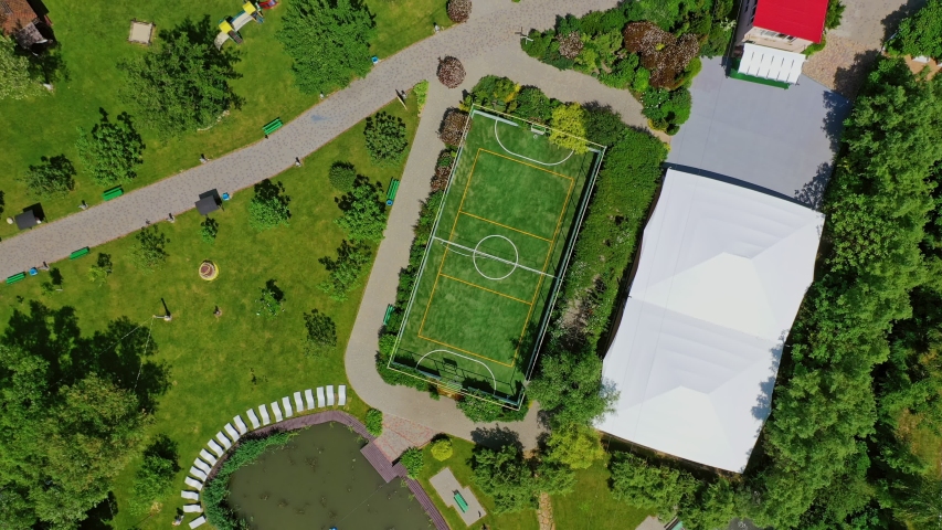 Green parks and playgrounds in recreation area. Modern resort area among nature in summer. Vacation center. Drone flight.