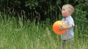 Boy throws a ball in the fresh air