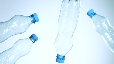 Super Slow Motion Shot of Flying Empty Plastic Bottles on Light Blue Gradient Background at 1000fps.