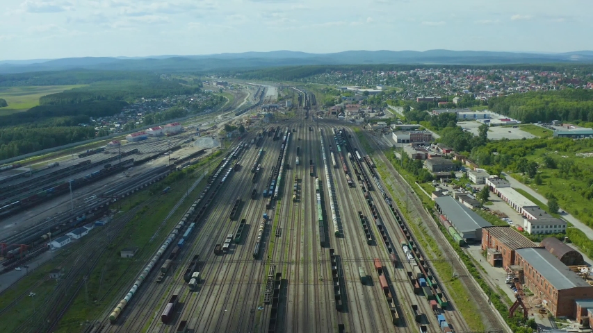 flight over the branches of railway tracks and a panoramic view of the large transport hub of the marshalling yard. Royalty-Free Stock Footage #1054721162