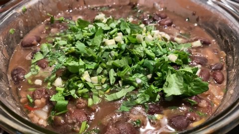 Red beans, cooking lobio at home. Home-made traditional Georgian cuisine. Chopped coriander and garlic on boiling beans