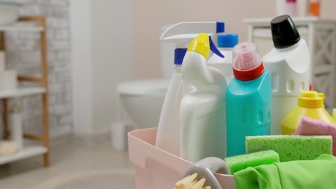 Basket with cleaning supplies in bathroom, closeup
