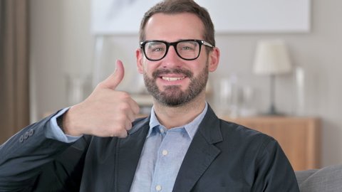 Portrait of Positive Young Businessman doing Thumbs up