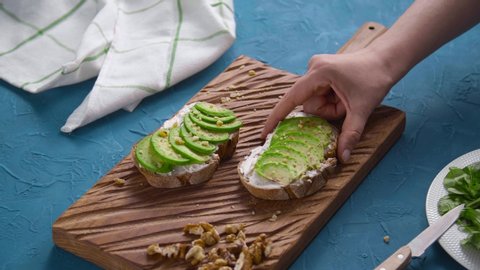 Healthy eating concept. Toast with avocado cream on the wooden board स्टॉक वीडियो
