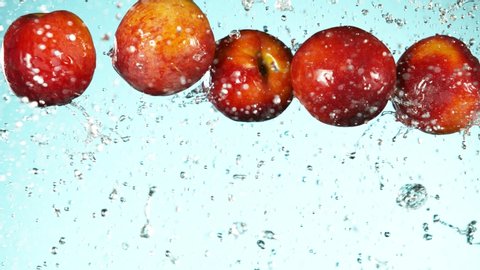 Super slow motion of falling peaches with water splashes. Filmed on high speed cinema camera, 1000fps