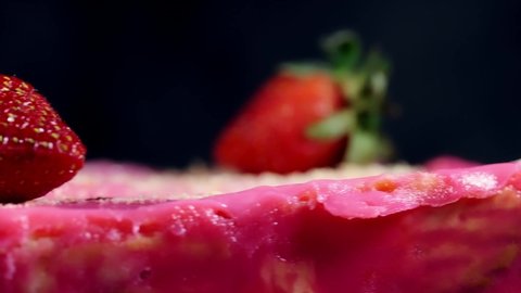A footage of rotating "batik" cake with shallow depth of field. It is frozen cake made with egg, butter, biscuits, milk and strawberry flavour. 