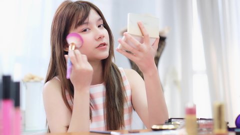 Makeup vlogger influencer creating cosmetic product explainer video. personal make up vlog.Young asian woman influencer beauty fashion blogger.
