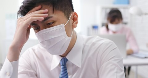 asian young businessman has headache or feel depress in office