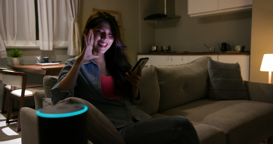 Woman using Voice Assistant controlling Light turning it on Video.