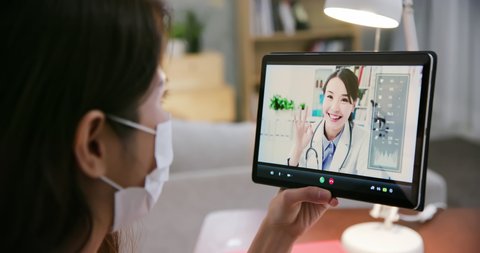 Telemedicine concept - asian female patient listening to doctor talking symptom on the internet and make a discussion with tablet pc