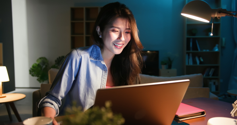 Asian business woman use computer and work from home in the evening | Shutterstock HD Video #1054729019