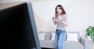 asian woman is playing motion sensing game and win at home