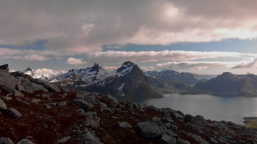 Aerial drone push in of panorama mountain view of Helgeland in northern Norway at golden hour Royalty-Free Stock Footage #1054729997