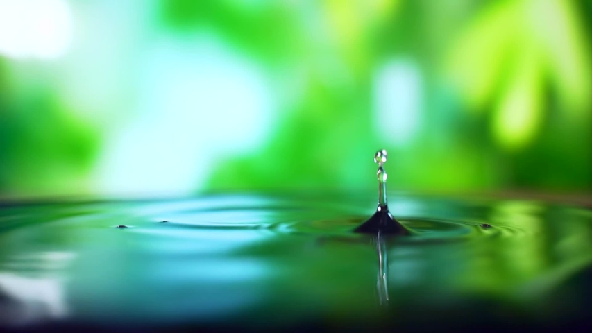 Close up. It is raining outside. Raindrops break into a puddle. water drop on nature background.	