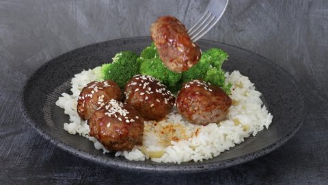Eating a Spicy Asian Meatball and White Rice
