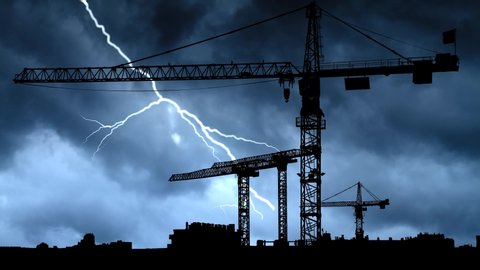 Construction Site with Big Tower Crane in Silhouette, Thunderstorm and Lightning Time Lapse , Under Construstion Concept