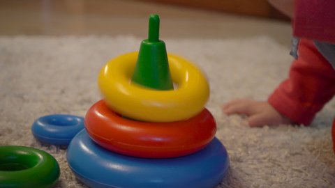  baby  playing with colorful  pyramid,playing baby with a pyramid toy folding on the carpet