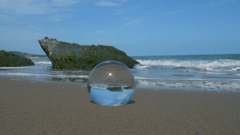 A crystal ball on the sandy beach of Wicklow, Ireland - close up
