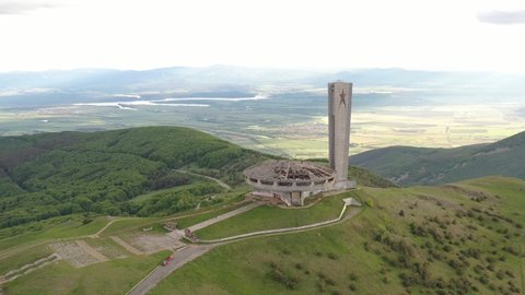 Buzludja, Bulgaria. Dron top view on
one of the largest in Europe abandoned communist monuments in the Balkan mountains, Bulgaria. UFO dish style building. Hipster destination in a beautiful mountain.