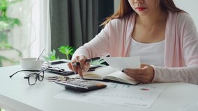 Stressed young woman calculating monthly home expenses, taxes, bank account balance and credit card bills payment, Income is not enough for expenses - Powered by Shutterstock - Get 15% off with code: PIKWIZARD15