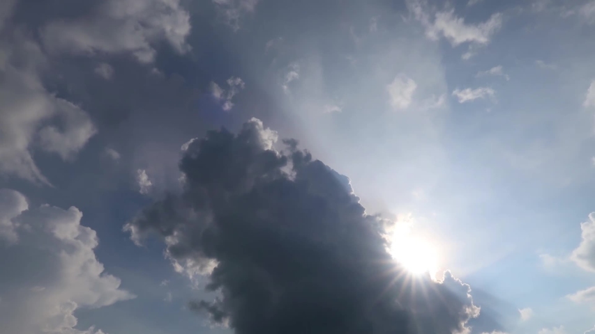 TimeLapse of beautiful sunny blue sky with bright sun light shining through white clouds & cumulus cloudscape in tropical summer or spring sunlight, sunbeam & sun ray flares at daylight sunshine day  Royalty-Free Stock Footage #1054735574