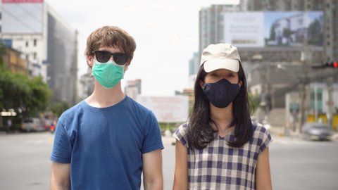 Coronavirus Pandemic: Portrait Young Multi Ethnic Couple Wearing Face Masks in City Timelapse