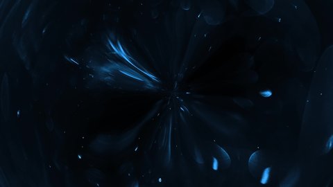 Blue paint drops mixing . dark blue abstract background. Magic ball