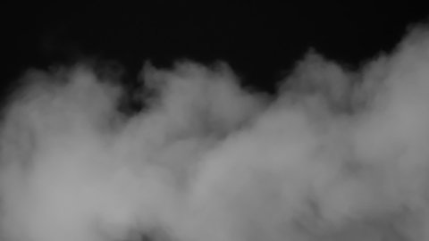 Cloud Slowly Descends. Clubs of white vapor similar to clouds move slowly on a black background