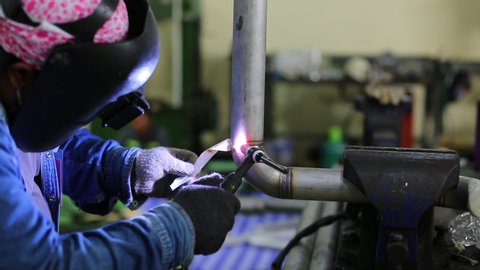 Male worker welding argon. male worker metal pipeline stainless