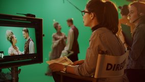 Famous Talented Female Director in Chair Looks at Display talks with Assistant while Shooting Blockbuster. Green Screen Scene in Historical Drama. On Film Studio Set Crew Doing High Budget Movie - Powered by Shutterstock - Get 15% off with code: PIKWIZARD15