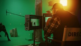 Director Looks at Displays Directs Green Screen CGI Scene with Actor Wearing Motion Tracking Suit and Head Rig. In the Big Film Studio Professional Crew Shooting Blockbuster Movie
