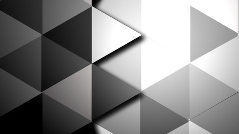Surface of triangles in different hints of gray turning one by one.