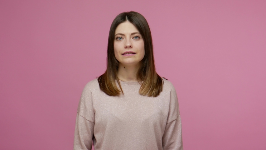 Clever brunette woman considering serious plan, solving problem in mind and nodding approvingly, thinking over smart idea, pondering and musing answer. indoor studio shot isolated on pink background | Shutterstock HD Video #1054742411