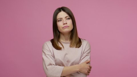 Clever brunette woman considering serious plan, solving problem in mind and nodding approvingly, thinking over smart idea, pondering and musing answer. indoor studio shot isolated on pink background
