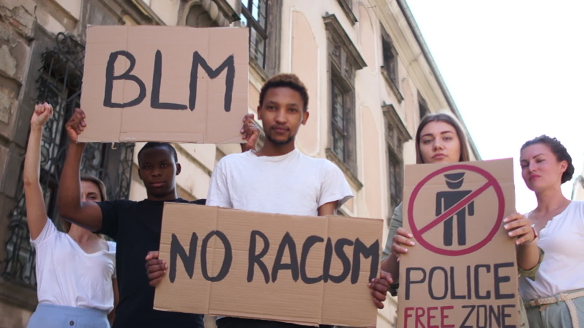 Peaceful Black Lives Matter Protest City Street. Mass protests in the usa. Multiracial group of people with posters blm, police free zone, no racism. Rallies against racism and police brutality | Shutterstock HD Video #1054744421
