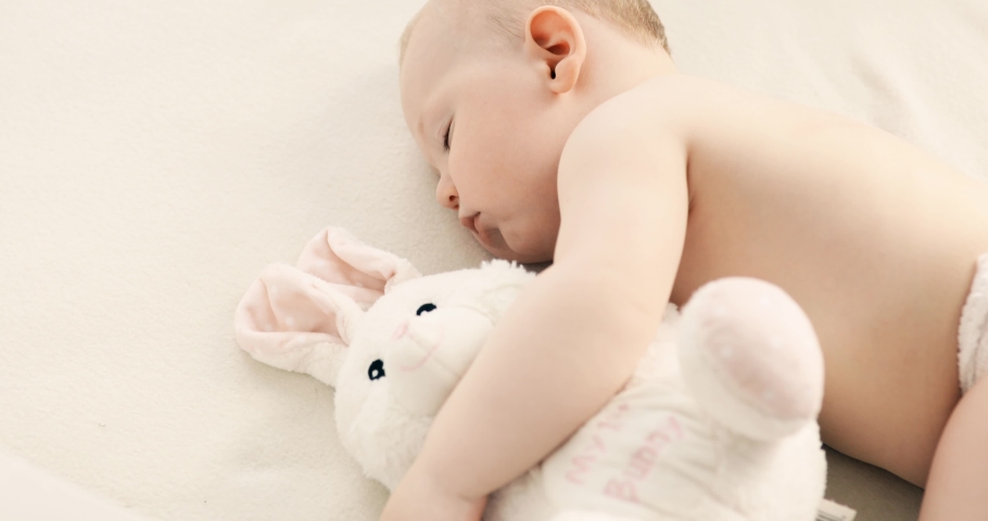 Funny baby sleeping on the bed at home. Children's day lower sleeping position | Shutterstock HD Video #1054745678