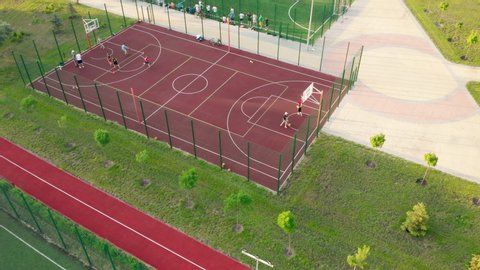 Aerial view. Park with basketball and soccer field and a training platform. City park with paths and green trees. Sports area