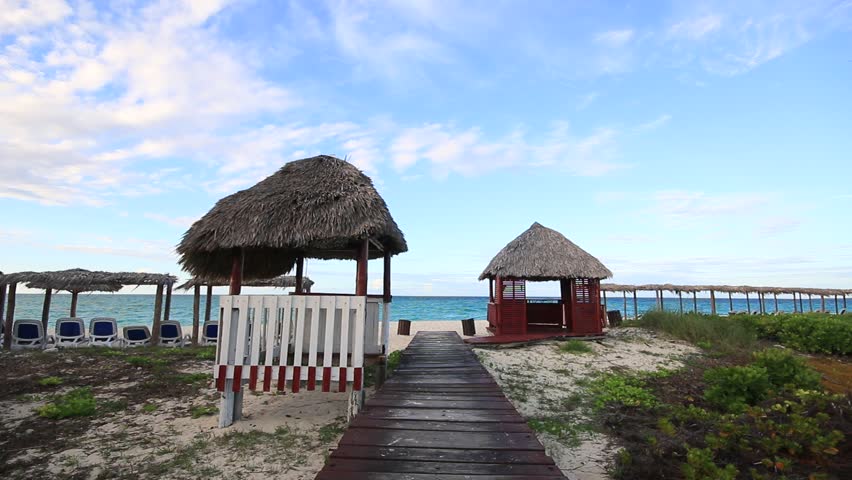 Seaside beach hut and boardwalk by blue water of Caribbean Sea in Cayo Santa Maria, Cuba