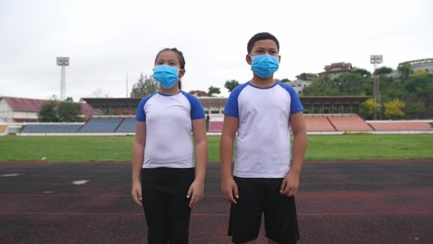 Asian Boy And Girl Takes Off Mask At Stadium