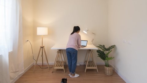 Timelapse of asian woman with pet set up room for work from home in quarantine social distance work remotely concept. New office setup, cleaning housework in new normal asia life or home decoration.