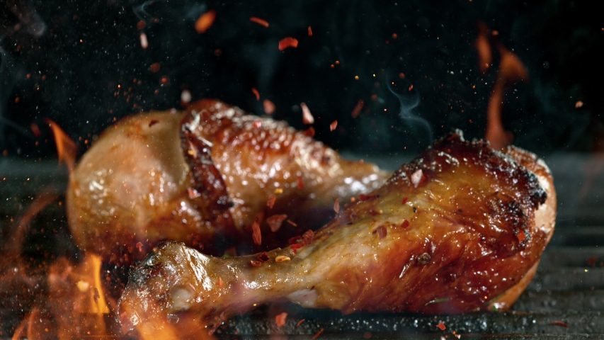 Close-up of falling raw tasty chicken legs on iron cast grate, super slow motion, filmed on high speed cinematic camera at 1000 fps. Royalty-Free Stock Footage #1054749833